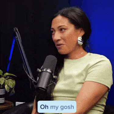 a woman sitting in front of a microphone with a sticker that says oh my gosh on it
