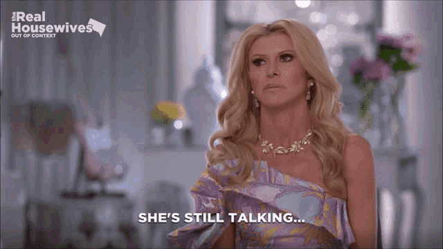 a woman says she 's still talking while wearing a purple top