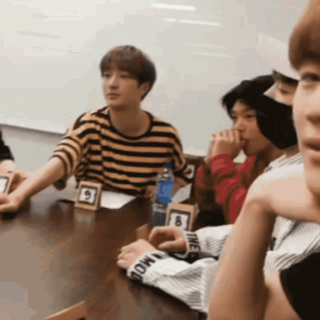 a group of people are sitting around a table with a card that says ' i love you ' on it