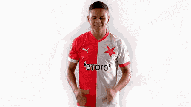 a man wearing a red and white shirt with etoro on the front