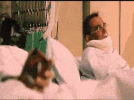 a man is laying in a hospital bed with a neck brace on his neck .