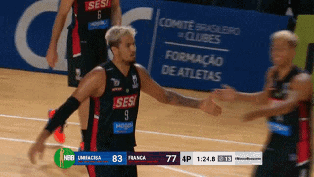 a basketball player in a sesi jersey is being hugged by another player