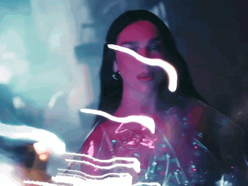 a woman 's face is partially obscured by a purple and white light