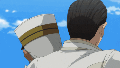 a man is holding a white hat with a gold stripe on it