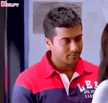 a man in a red and blue shirt is looking at a woman in a locker room .