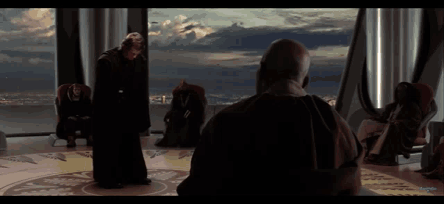 a man in a black robe is standing in front of a group of men