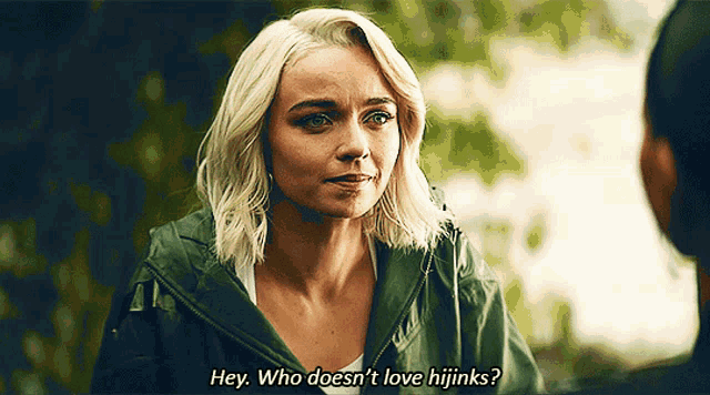 a woman in a green jacket says " hey who does n't love hijinks "