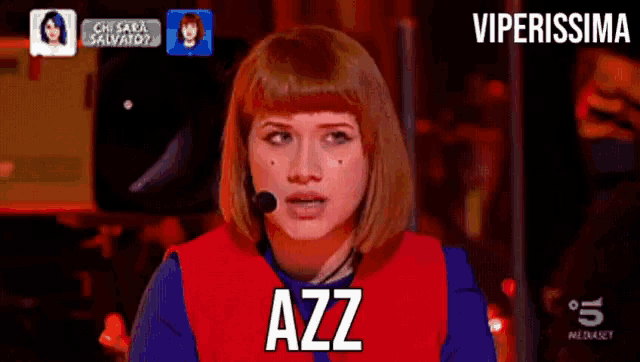 a woman wearing a red vest that says azz