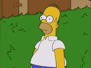 a cartoon of homer simpson standing in front of a green bush