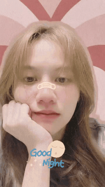a girl with a bandage on her nose and the words good night