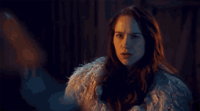 a woman in a fur coat with the words " you 've made an enemy this friday " above her