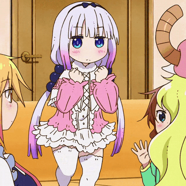 a girl in a pink and white dress is standing next to another girl with horns