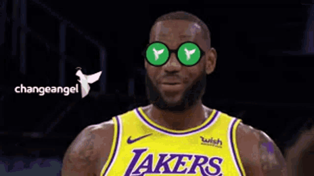 a man wearing a lakers jersey and sunglasses