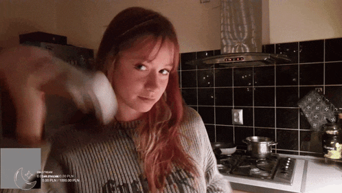 a woman standing in a kitchen with a sign that says ' do not stream ' at the bottom