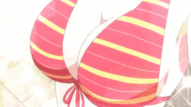 a close up of a woman 's breasts in a striped bikini top