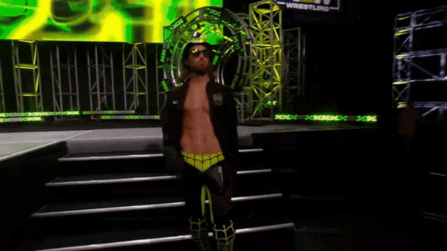a man wearing sunglasses and a hat stands on a stage in front of a sign that says ' smackdown '