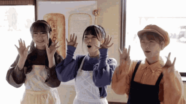 three girls wearing aprons and hats are dancing in front of a sign that says " bread "