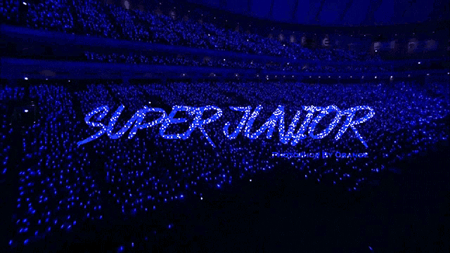 a stadium full of blue lights with the word super junior written in the middle