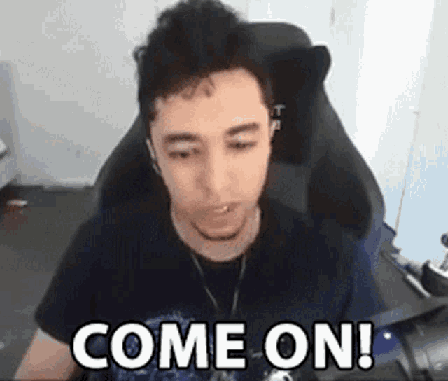 a man is sitting in a chair and saying `` come on ! ''
