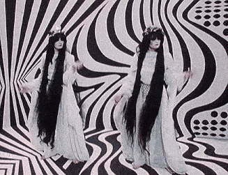 two women with long hair are standing in front of a striped wall .