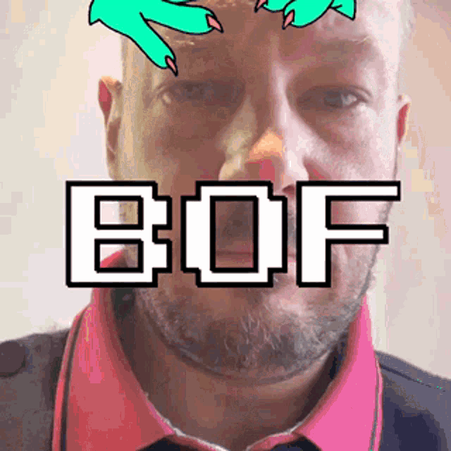a man with a beard is wearing a pink shirt and the word bof is on his face