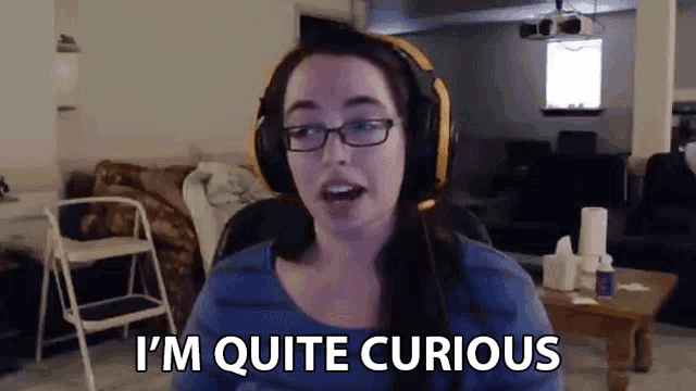 a woman wearing headphones and glasses is saying i 'm quite curious .