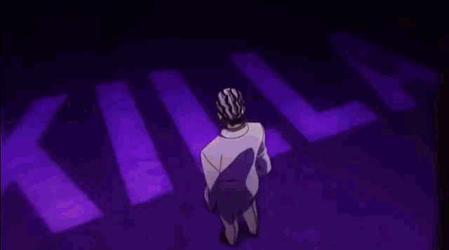 a man is standing in a dark room with a purple background .
