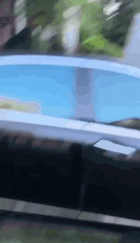 a blurred image of a swimming pool with a person swimming in it