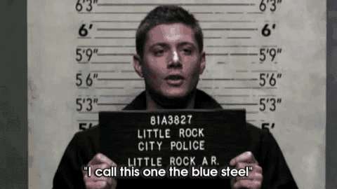 a man is holding up a mug shot from little rock city police
