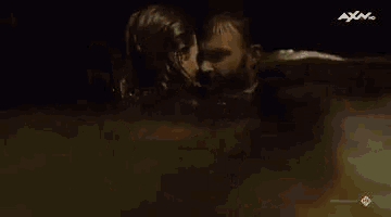 a man and a woman are standing in a bathtub .