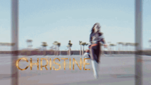 a blurred image of a person with the name christine written in gold