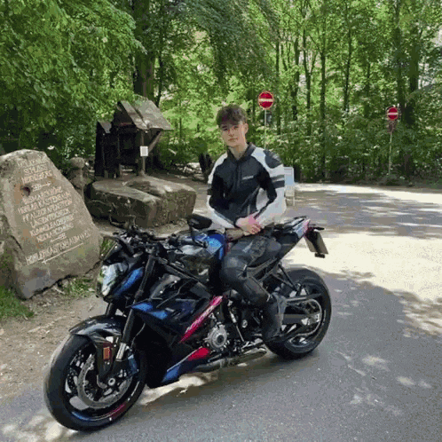 a man is sitting on a motorcycle in front of a sign that says no passing