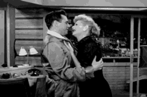 a man and a woman are hugging and kissing in a black and white photo