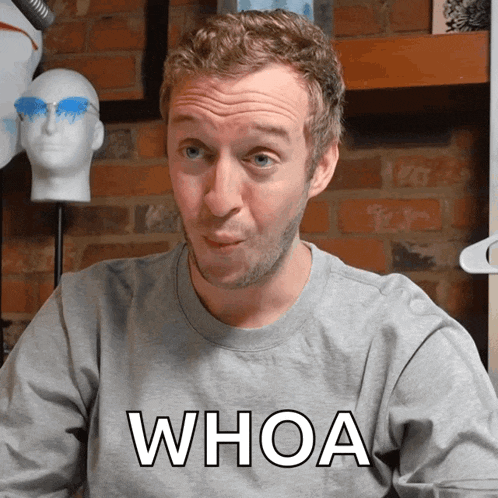 a man wearing a gray shirt that says whoa