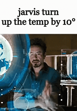 a man is sitting in front of a screen with the words jarvis turn up the temp by 10 degrees on it .