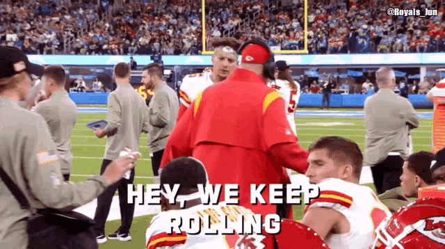 a football player says hey we keep rolling while sitting on the field