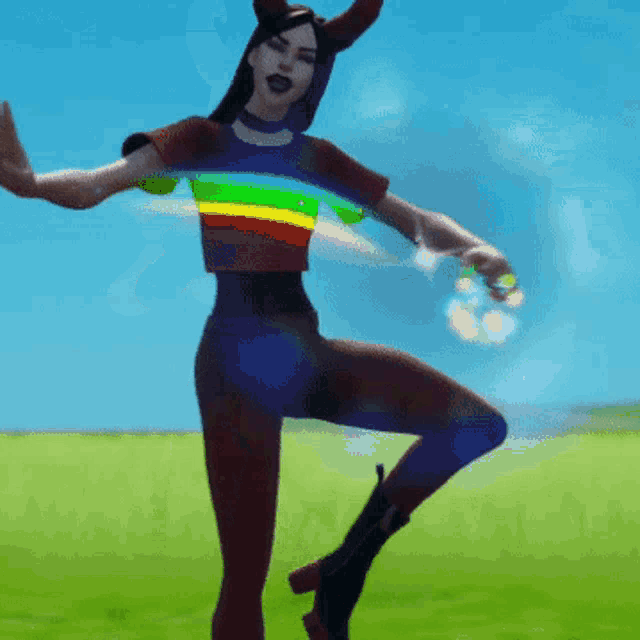 a woman is dancing with a rainbow colored hoop around her waist