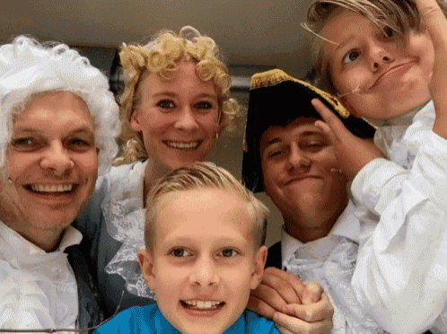 a group of people posing for a picture with one of them wearing a pirate hat