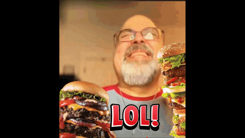 a man with a beard and glasses is holding two hamburgers in front of him with the words lol written in red