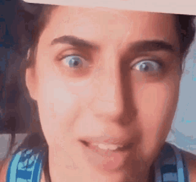 a close up of a woman 's face with her mouth open