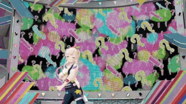a girl stands in front of a large screen that has a pattern of hearts and question marks on it