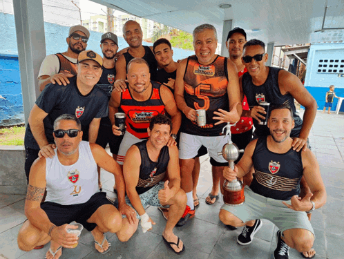 a group of men are posing for a picture and one of them is wearing a shirt that says samurai