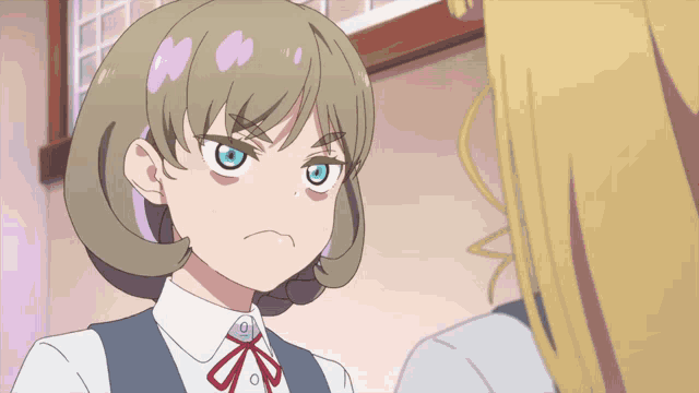 a girl with blonde hair and blue eyes looks angry at another girl