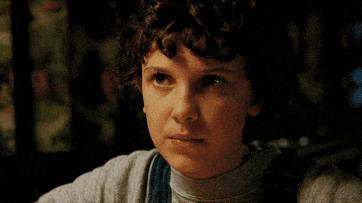 a close up of a young girl 's face with her eyes closed