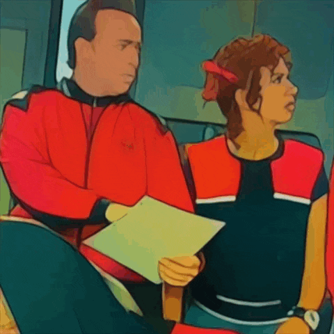 a man in a red jacket is talking to a woman