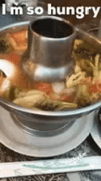 a bowl of soup with the words " i 'm so hungry " written on it