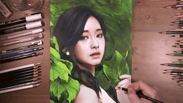a drawing of a woman surrounded by green leaves is on a table