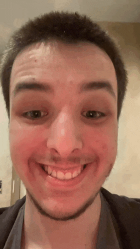 a close up of a man 's face with a smile on it