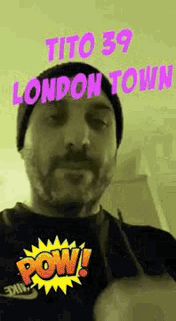 a man with a beard wearing a beanie and a black shirt with the words tito 39 london town on it .
