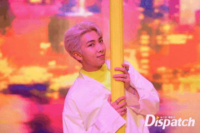 a man holding a yellow pole in front of a dispatch ad